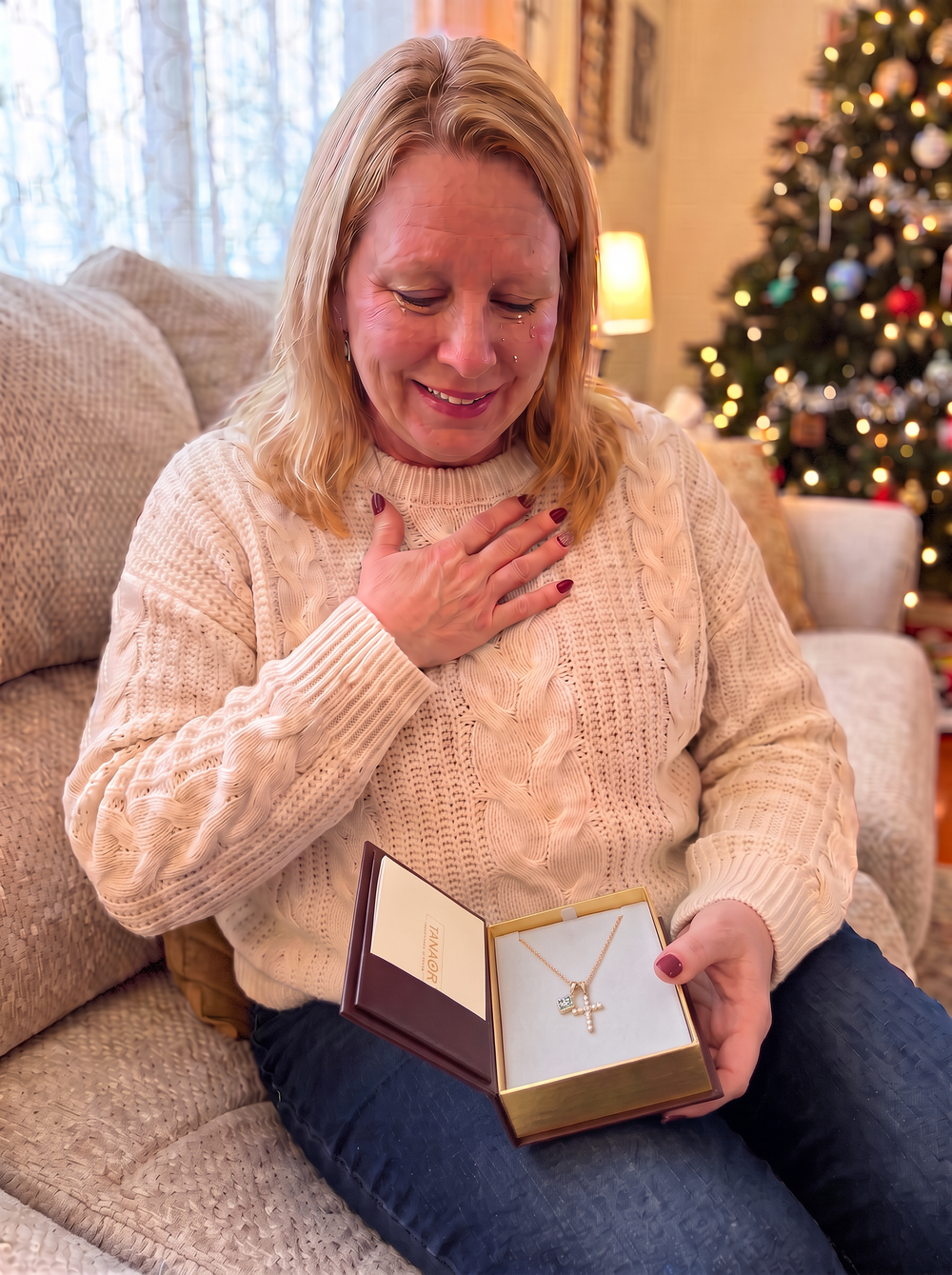 A woman moved to tears opening the TANAOR Bible gift box with the Sacred Cross Necklace inside